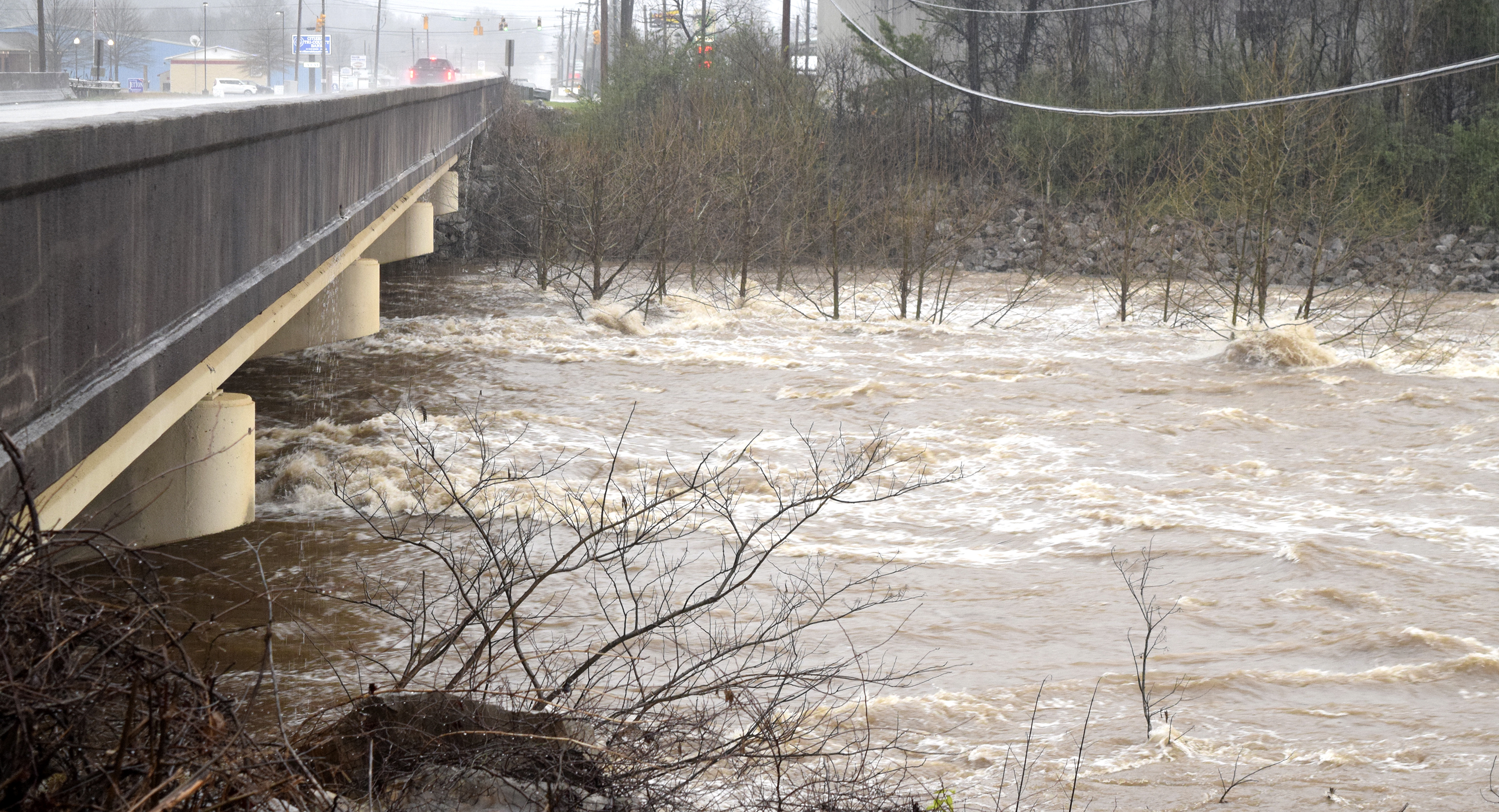 The waters of North Chickmauga Creek churn past the U.S. 27 bridge in the Mile Straight community. Heavy rains caused flooding and road closures across Hamilton County on Christmas Day.
