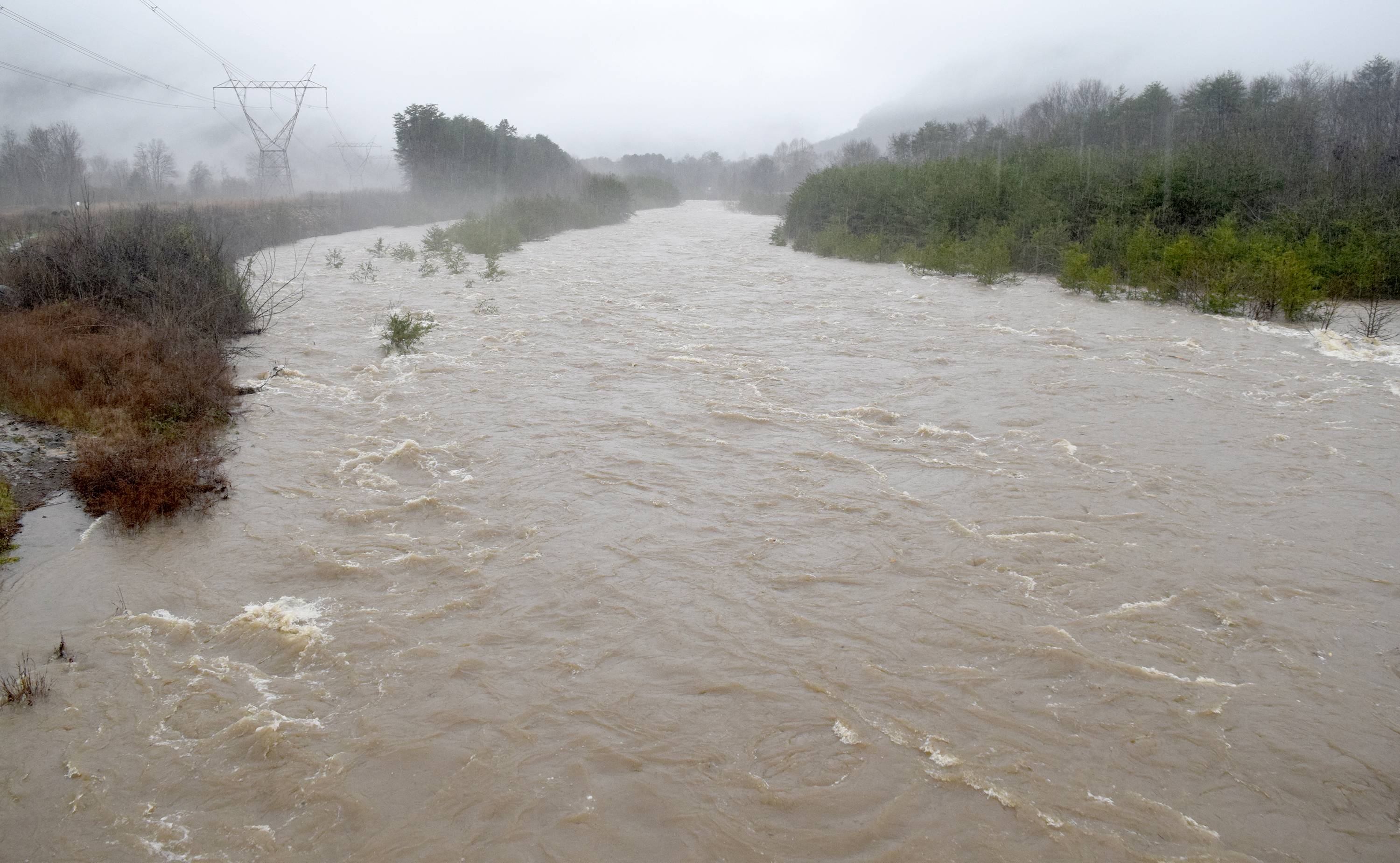 The waters of North Chickmauga Creek churn toward the U.S. 27 bridge in the Mile Straight community. Heavy rains caused flooding and road closures across Hamilton County on Christmas Day.
