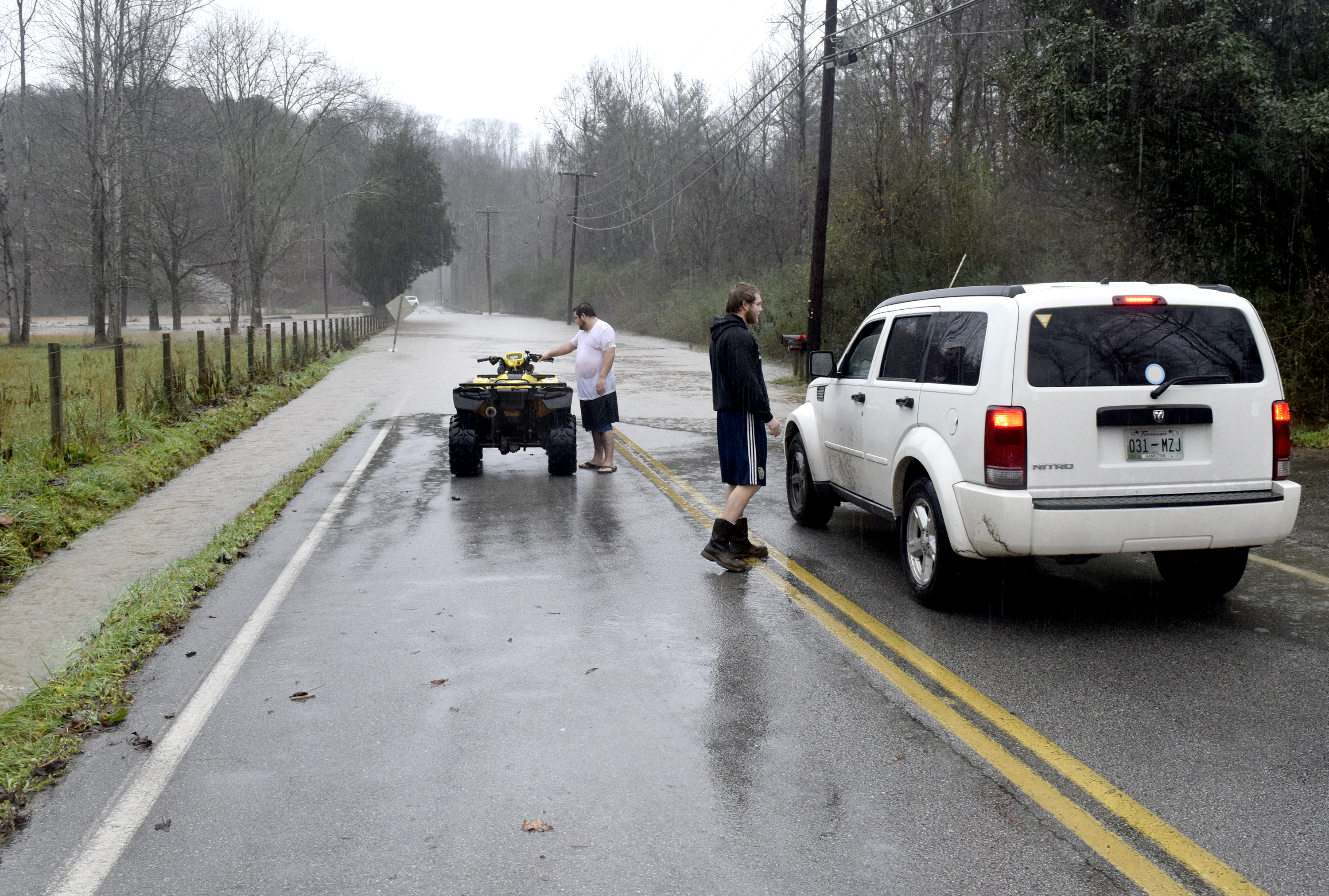 Falling Water residents gather at the northern end of a flooded section of Roberts Mill Road. Heavy rains caused flooding and road closures across Hamilton County on Christmas Day.