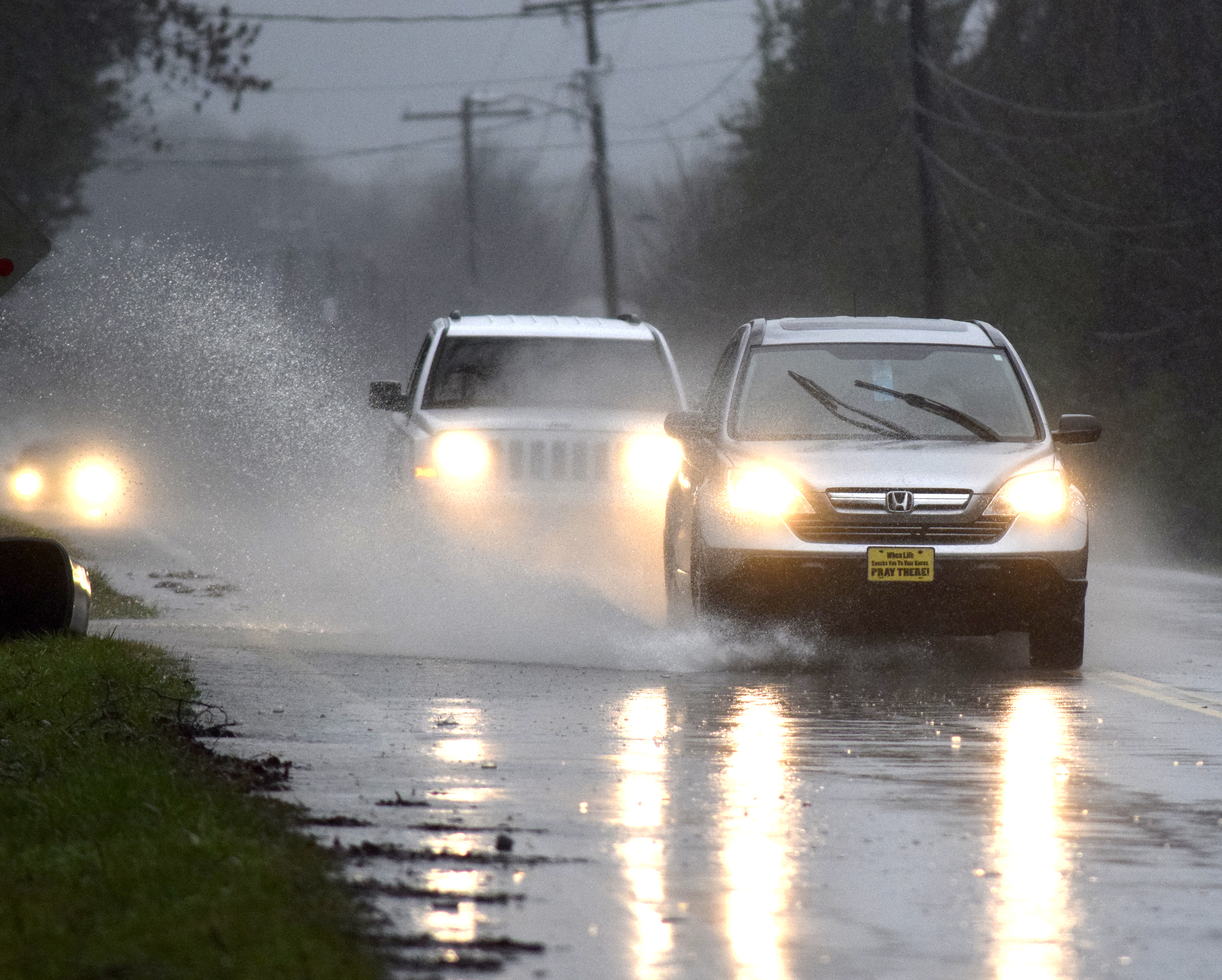Cars splash through standing water on U.S. 27 in the Falling Water Community. Heavy rains caused flooding and road closures across Hamilton County on Christmas Day.
