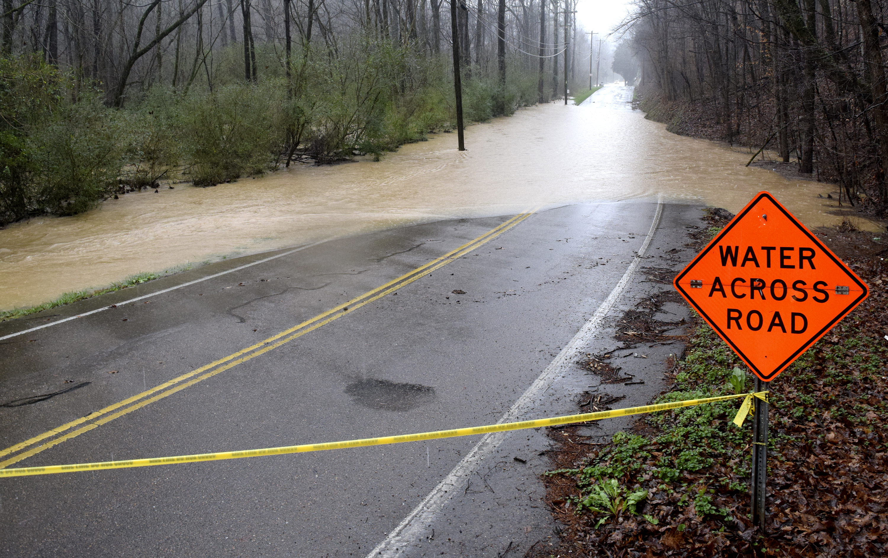 The floodwaters of Falling Water Creek block the south end of Roberts Mill Road. Water covered at least two secitons of the road in the Falling Water Community. Heavy rains caused flooding and road closures across Hamilton County on Christmas Day.