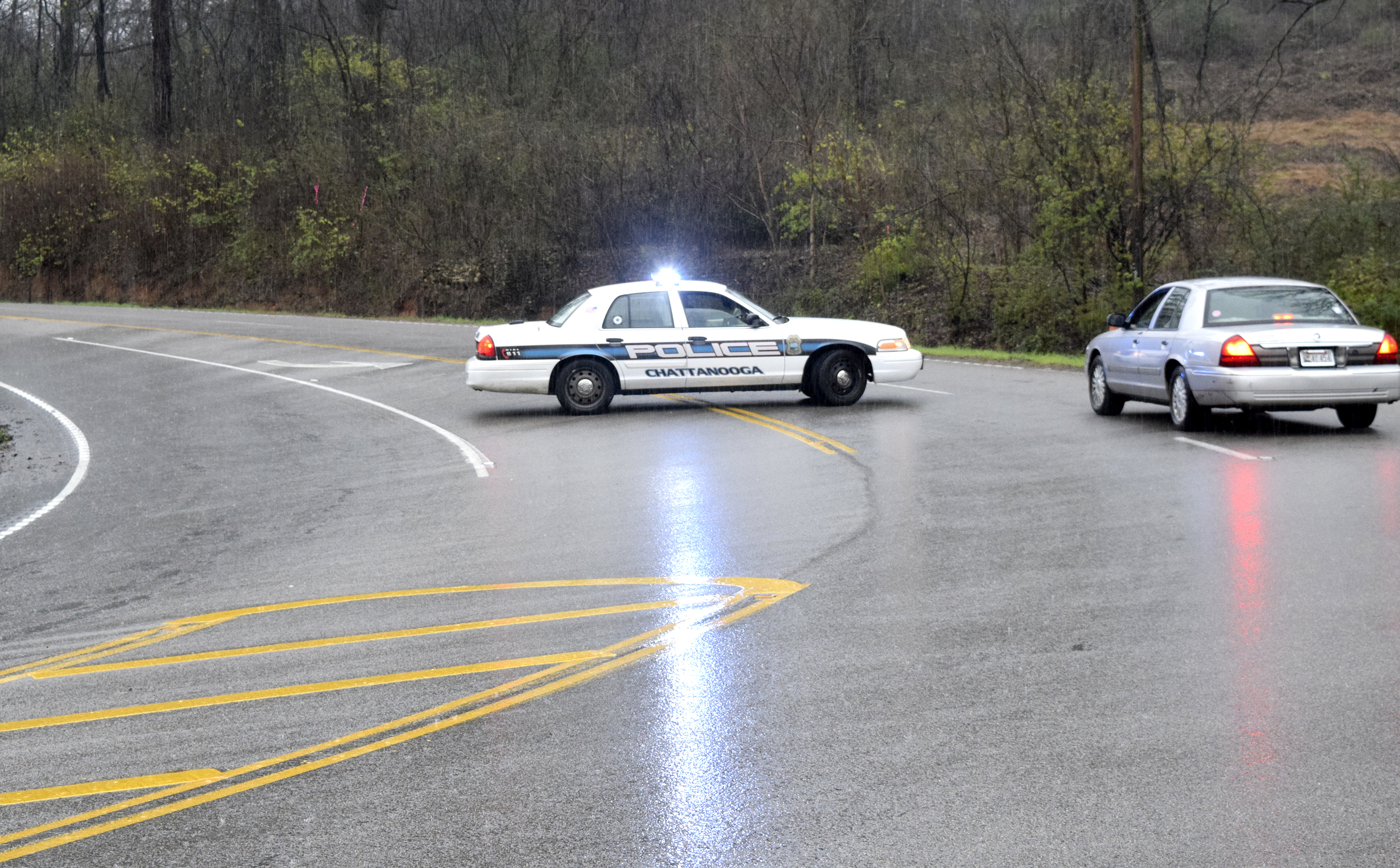 A Chattanooga Police officer turns traffic away on Signal Mountain Road at the base of the mountain. Rains have caused a rock slide closing the road. Heavy rains caused flooding and road closures across Hamilton County on Christmas Day.