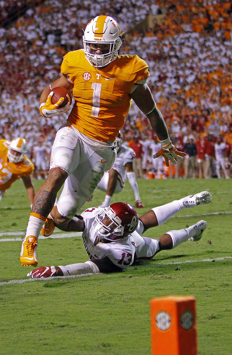 Tennessee running back Jalen Hurd (1) escapes Oklahoma safety Ahmad Thomas to score an overtime touchdown during the Sooners' win in Knoxville in September. Hurd ran for 100-plus yards against the stout defenses of Oklahoma, Florida, Missouri and Vanderbilt.