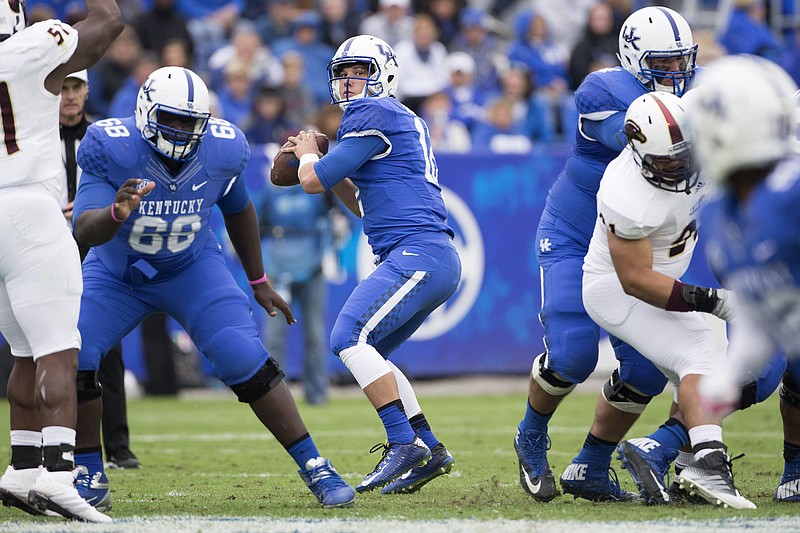 Kentucky quarterback Reese Phillips looks for a receiver during the second half of an NCAA college football game against Louisiana Monroe at Commonwealth Stadium in Lexington, Ky., Saturday, Oct. 11, 2014. Kentucky won the game 48-14. (AP Photo/David Stephenson)