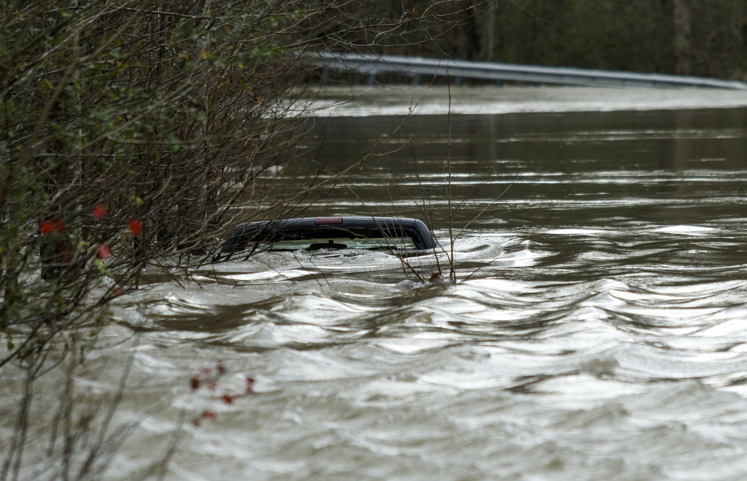 A truck is submerged in floodwaters that overtook Old Hixson Pike after heavy rains brought flooding to the region Saturday, Dec. 26, 2015, in Hixson, Tenn. Rain is expected to continue into the next week.