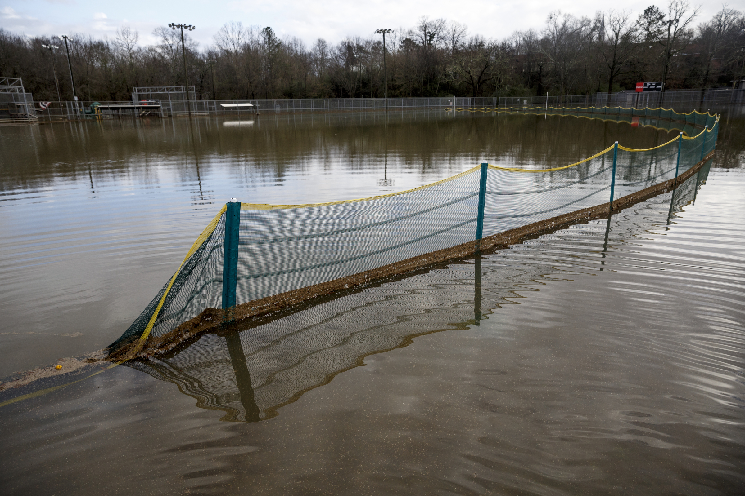 A softball fence is visible in floodwaters covering Hixson United Methodist Church's ballfields after heavy rains brought flooding to the region Saturday, Dec. 26, 2015, in Chattanooga, Tenn. Rain is expected to continue into the next week.