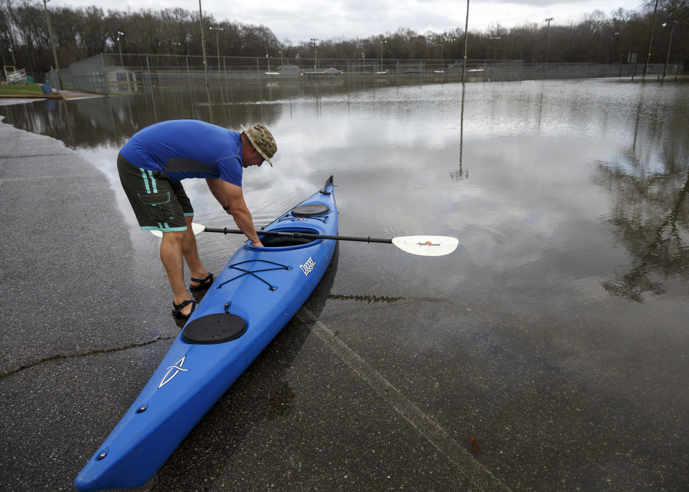 Andrew Peaker packs up his kayak after kayaking through Hixson United Methodist Church's flooded ballfields after heavy rains brought flooding to the region Saturday, Dec. 26, 2015, in Chattanooga, Tenn. Rain is expected to continue into the next week.