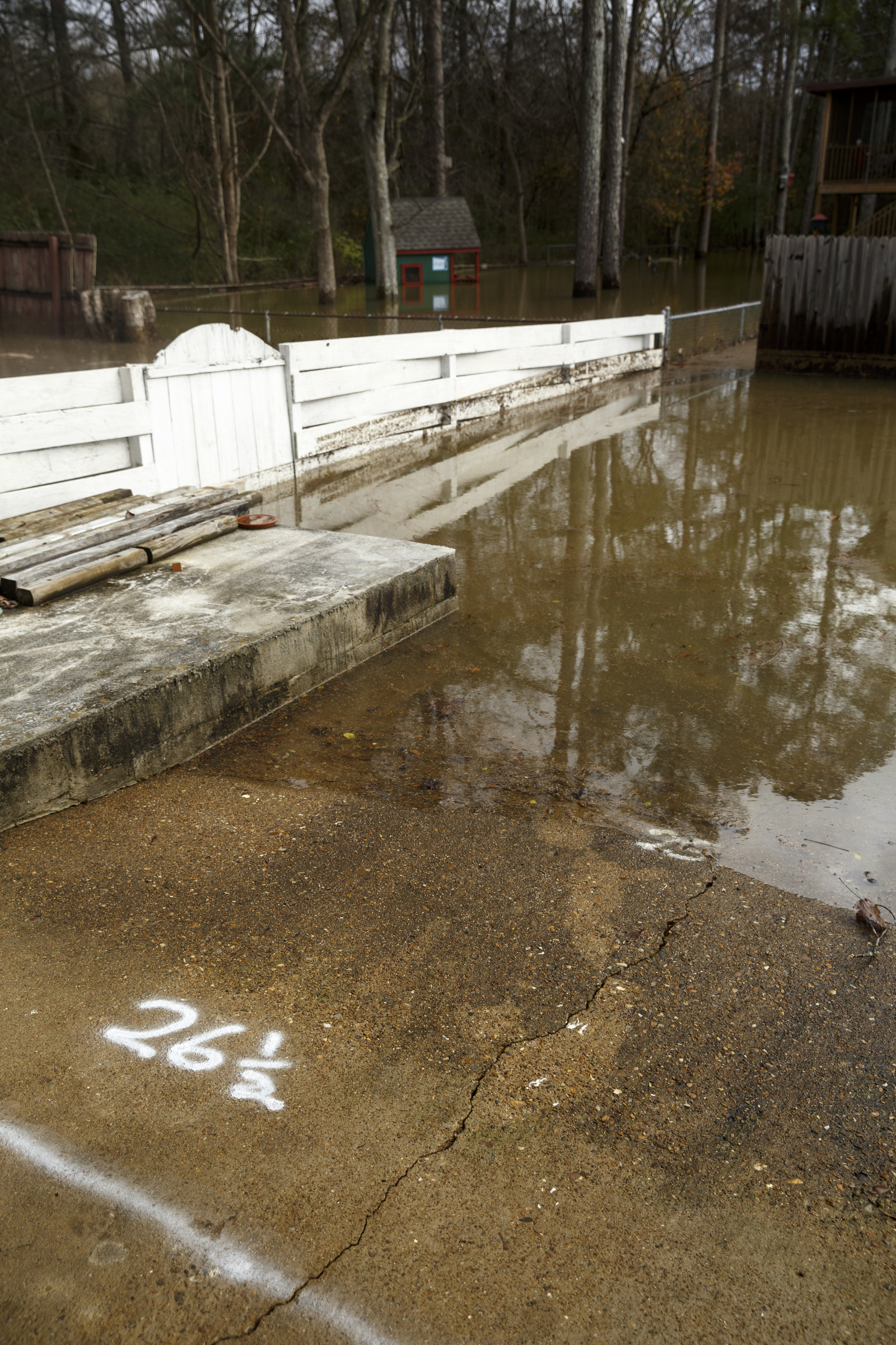 A resident who lives on Nottingham Drive used spray paint to mark the high-water level on his driveway after Christmas day rainfall brought South Chickamauga Creek to a flood stage of about 26.5 feet on Sunday, Dec. 27, 2015, in East Ridge, Tenn. Major flood stage classification for the creek is 27 feet.