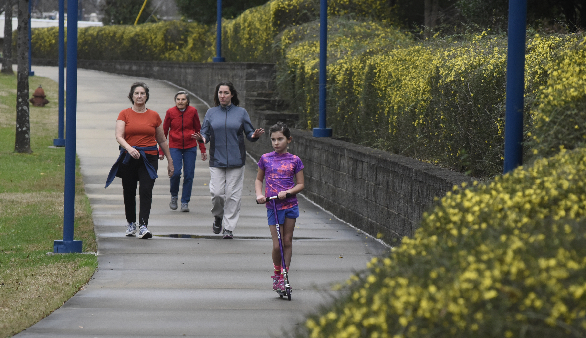 Arwyn LaRock rides a scooter as she uses the Tennessee Riverwalk with Jackie Wallace, Eleanor Waggoner and Genevie Wallace, from left, on Monday, Dec. 28, 2015, in Chattanooga, Tenn. Four generations living in Chattanooga, they went for a walk just before another round of rain soaked the area.
