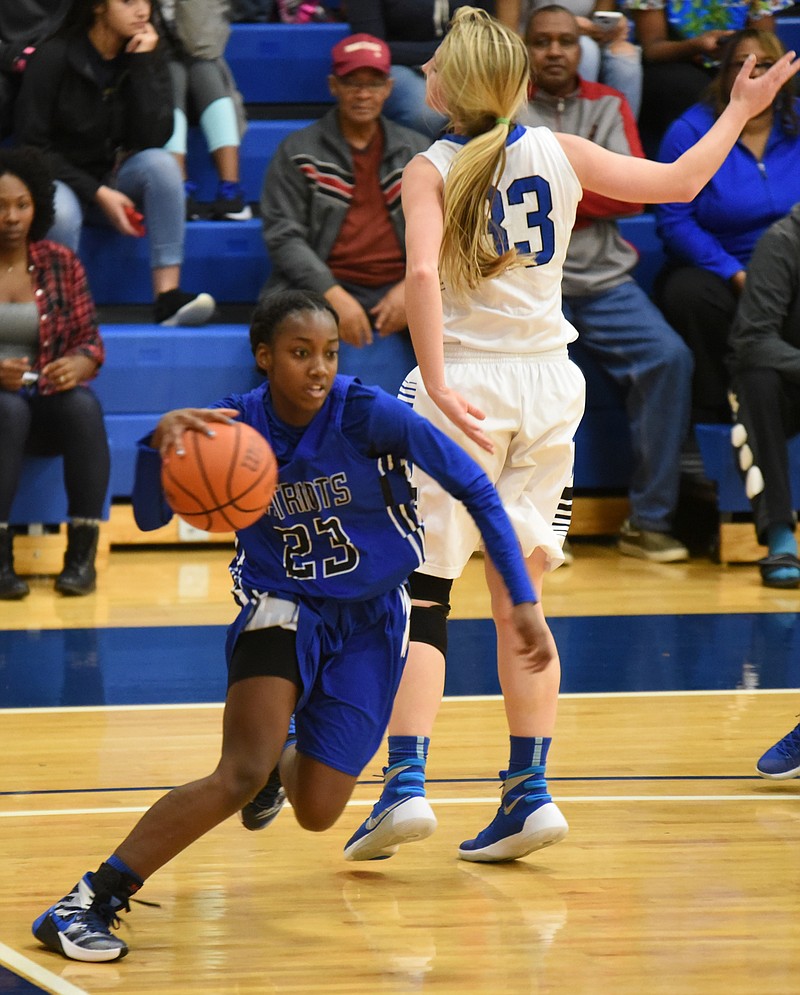 Arts and Sciences' Lennex Walker (23) breaks to the basket around GPS' Hannah Kincer (33). The Lady Patriots defeated GPS 45-30 in the girls semifinal at 4 p.m.
