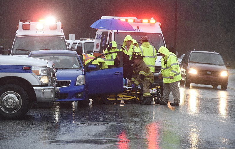 Emergency workers remove Fort Oglethorpe resident Samantha Miller from her blue Nissan on Monday, Dec. 28, 2015, in East Ridge, Tenn., to transport her in an Angel EMS ambulance after her car was struck in the rear by a Puckett EMS ambulance at the intersection of Seminole and Ringgold roads.