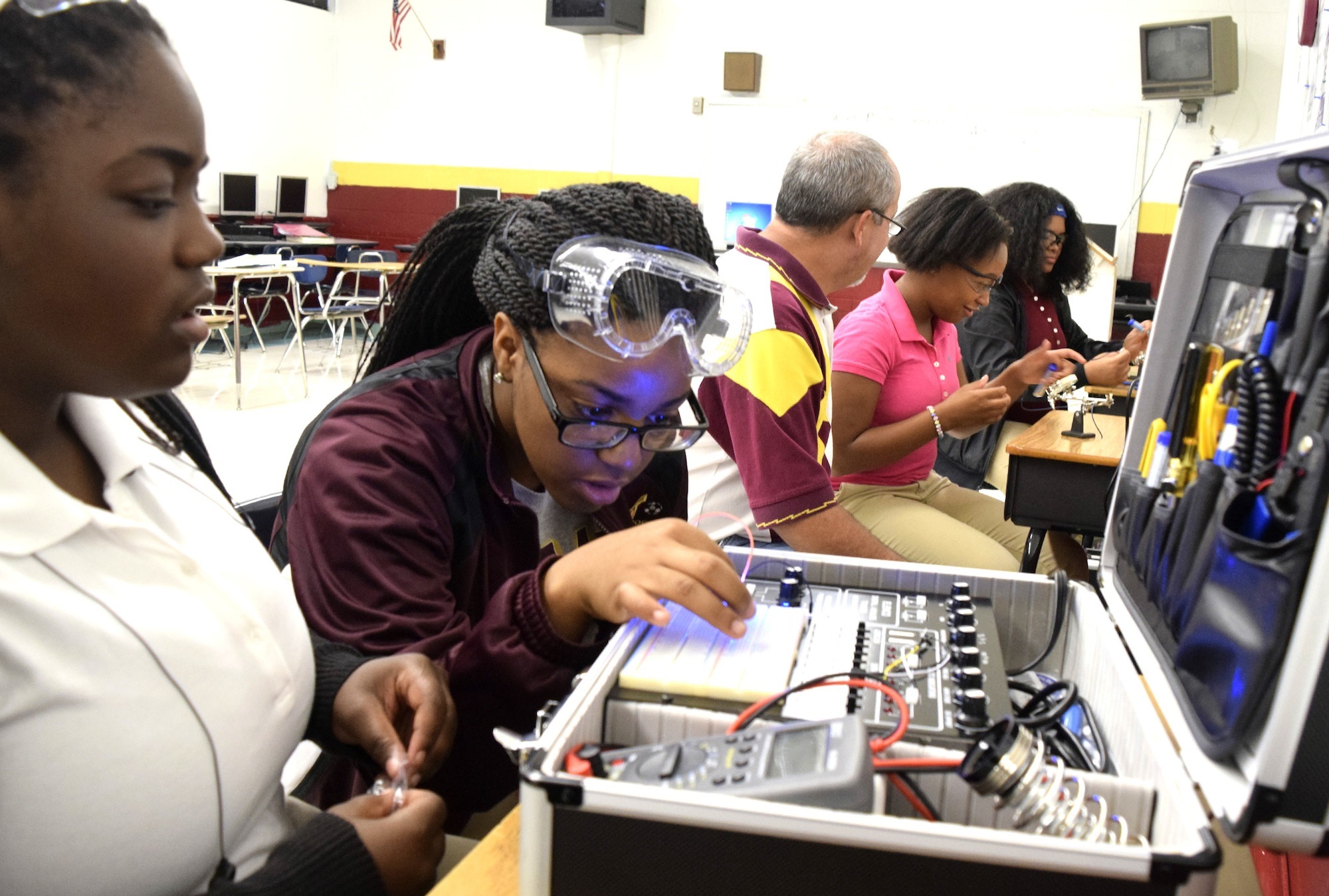 Tyner Academy students Jada Beckett and Takayla Sanford, from left, work on building circuits on the digital analog trainer, while teacher Bryan Robinson instructs Brookeana Willams and Noemy Marberry about soldering. Robinson has started a mechatronics program that offers student the opportunity to graduate with a specific certification that will aid them in finding jobs with high-tech companies. The program is funded in part by Gestamp.