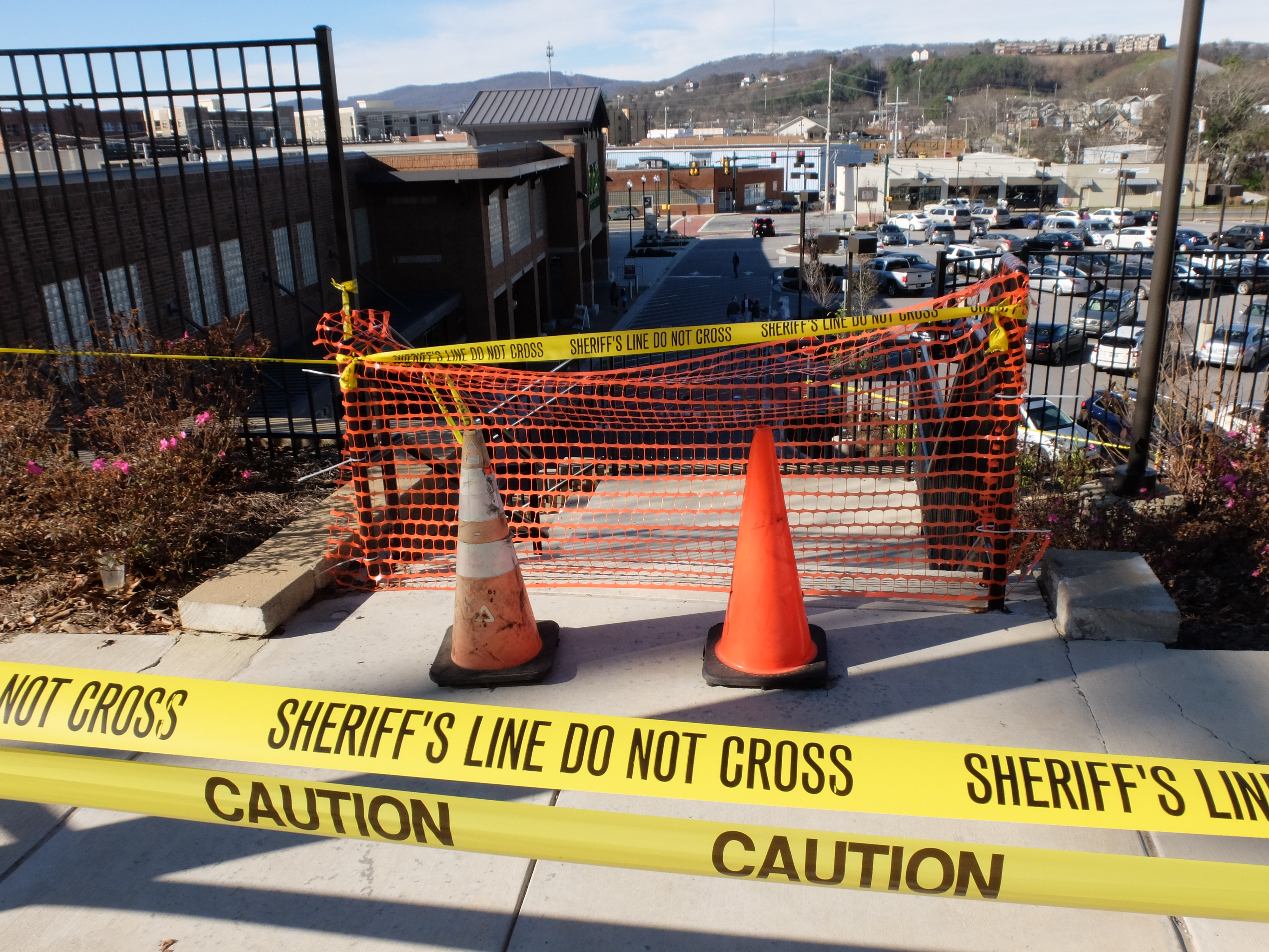 Steps leading to the Publix parking lot are closed as the huge retaining wall to the east is suspected of moving as a result of recent heavy rains. Yellow caution tape blocks the sidewalk and sand bags have been placed in the roadway along Woodland and Hamilton Avenues.