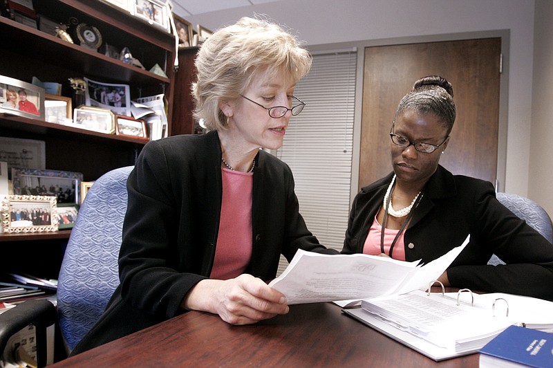 In this 2007 file photo, Ann Butterworth, left, Tennessee State Comptroller Justin Wilson's assistant for public finance, works with former open records specialist Elisha Hodge in Nashville, Tenn., Dec. 17, 2007. (AP Photo/Mark Humphrey)