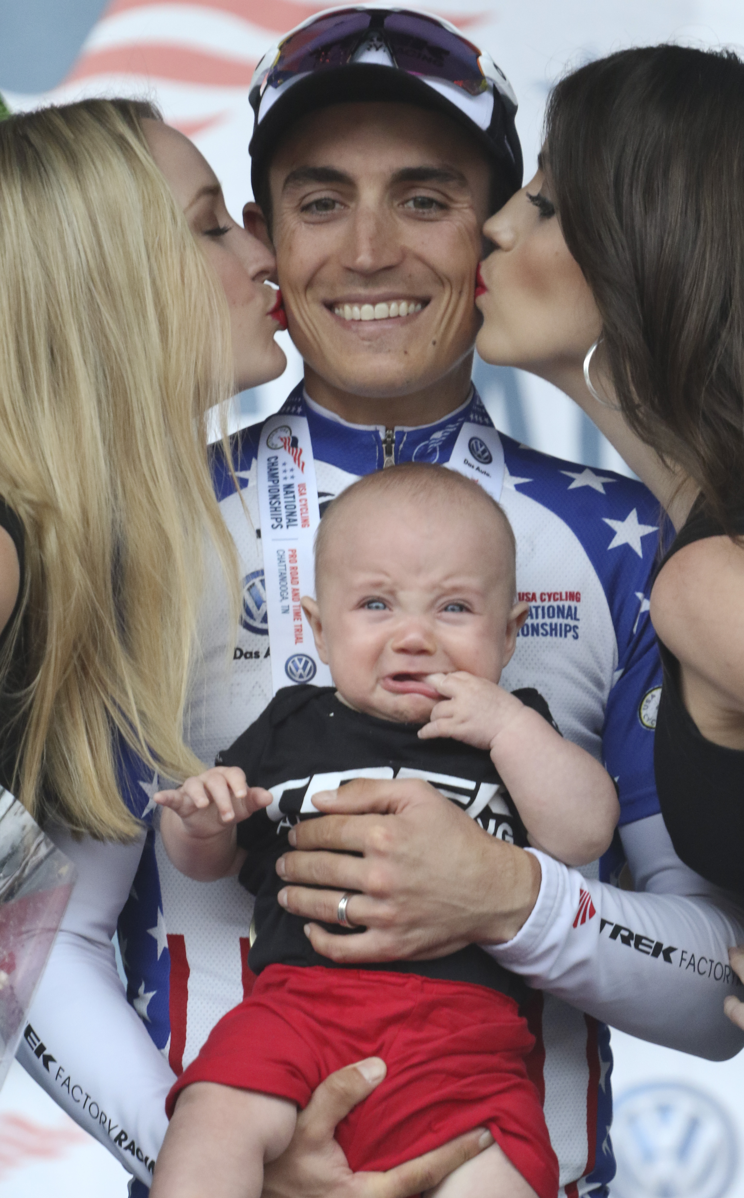 Matthew Bush holds his son, Noah, after winning the 2015 Volkswagen USA Cycling Pro Road & Time Trial National Championships.
