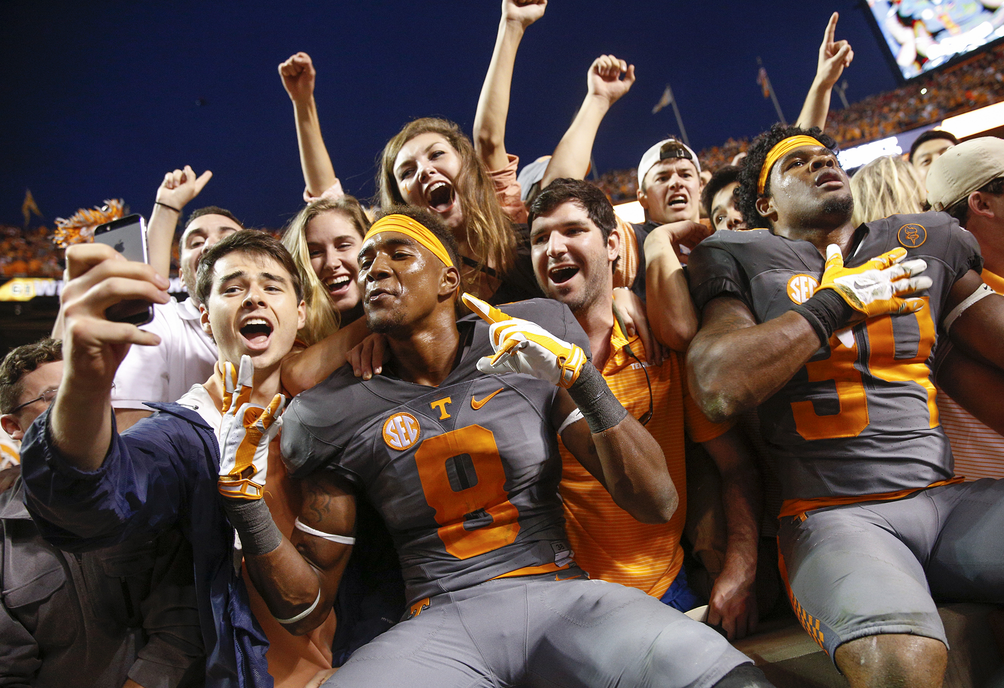 Tennessee cornerback Justin Martin (8) and defensive lineman Kendal Vickers (39) celebrate with the student section after their SEC conference football victory over Georgia at Neyland Stadium on Oct. 10.