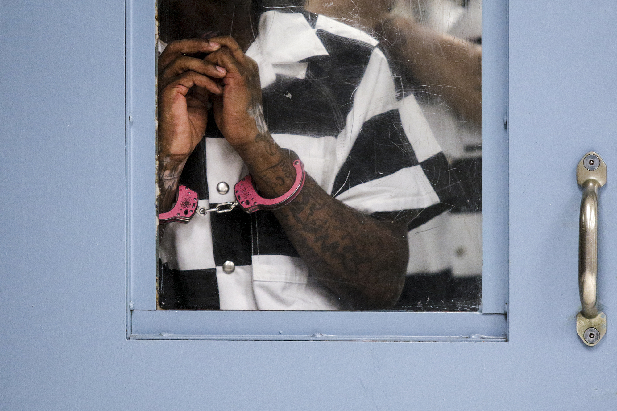 An inmate waits to be processed in an intake holding cell on June 30 before being incarcerated in Silverdale Correctional Facility in Chattanooga.