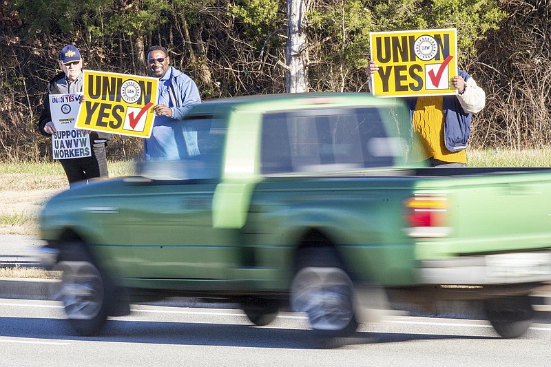 Union supporters hold up signs near the Volkswagen plant in Chattanooga, Tenn., on Friday, Dec. 4, 2015.