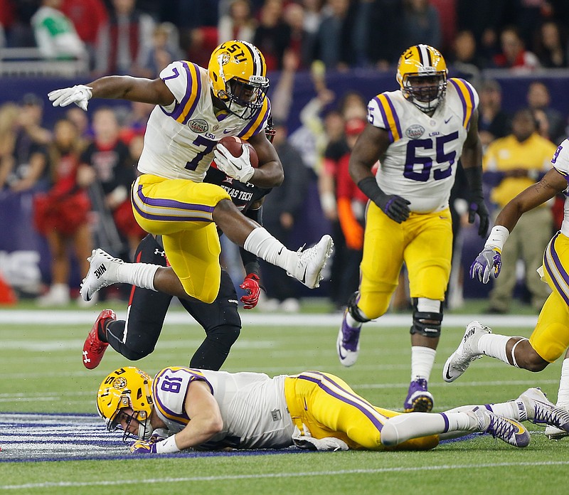 
              LSU running back Leonard Fournette (7) hurdles tight end Colin Jeter (81) as he rushes against Texas Tech during the first half of the Texas Bowl NCAA college football game Tuesday, Dec. 29, 2015, in Houston. (AP Photo/Bob Levey)
            