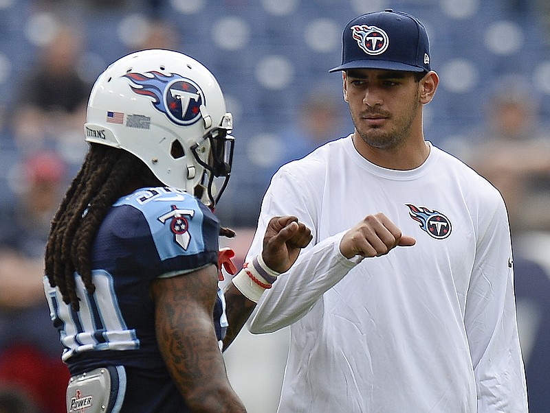 
              FILE - In this Sunday, Dec. 27, 2015, file photo, injured Tennessee Titans quarterback Marcus Mariota, right, greets cornerback B. W. Webb (38) before an NFL football game against the Houston Texan in Nashville, Tenn. Mariota's season is over. Titans interim head coach Mike Mularkey says it's "not worth the risk" of playing the rookie in their season finale Sunday at Indianapolis.  (AP Photo/Mark Zaleski, File)
            