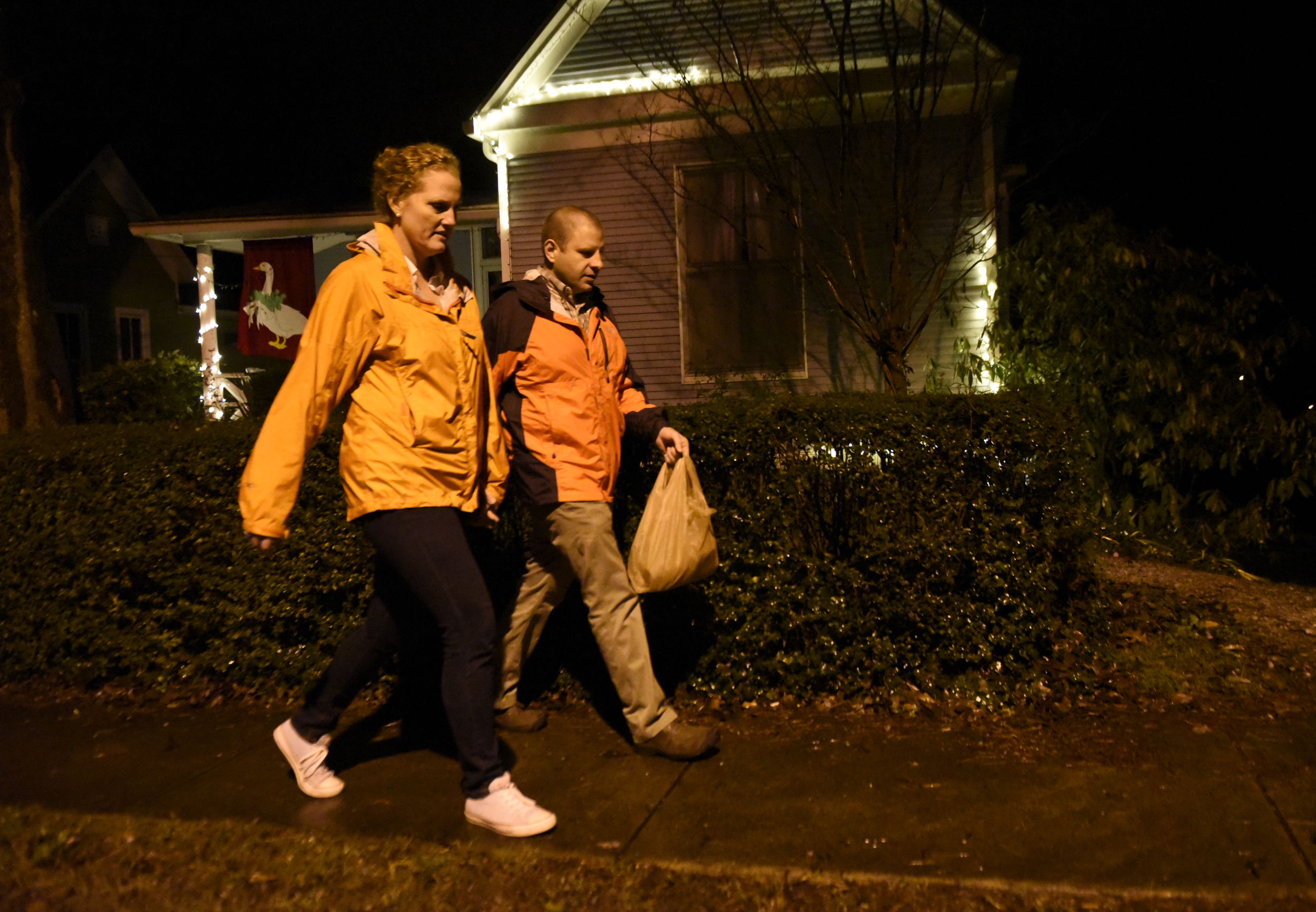 Jennifer and Carl Sheffield walk to visit neighbors on Wednesday, Dec. 23, 2015, in Chattanooga, Tenn.