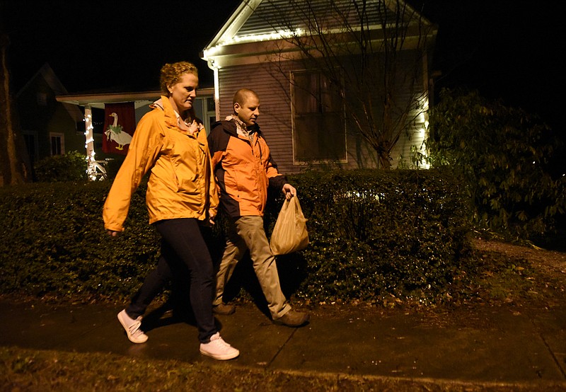 Jennifer and Carl Sheffield walk to visit neighbors on Wednesday, Dec. 23, 2015, in Chattanooga, Tenn.