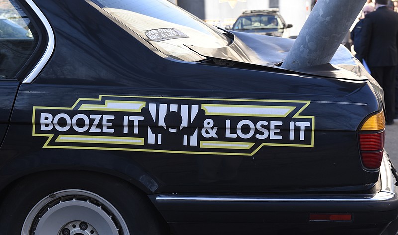 The slogan "booze it and lose it" is seen on a car displayed as the Tennessee Highway Patrol in December.