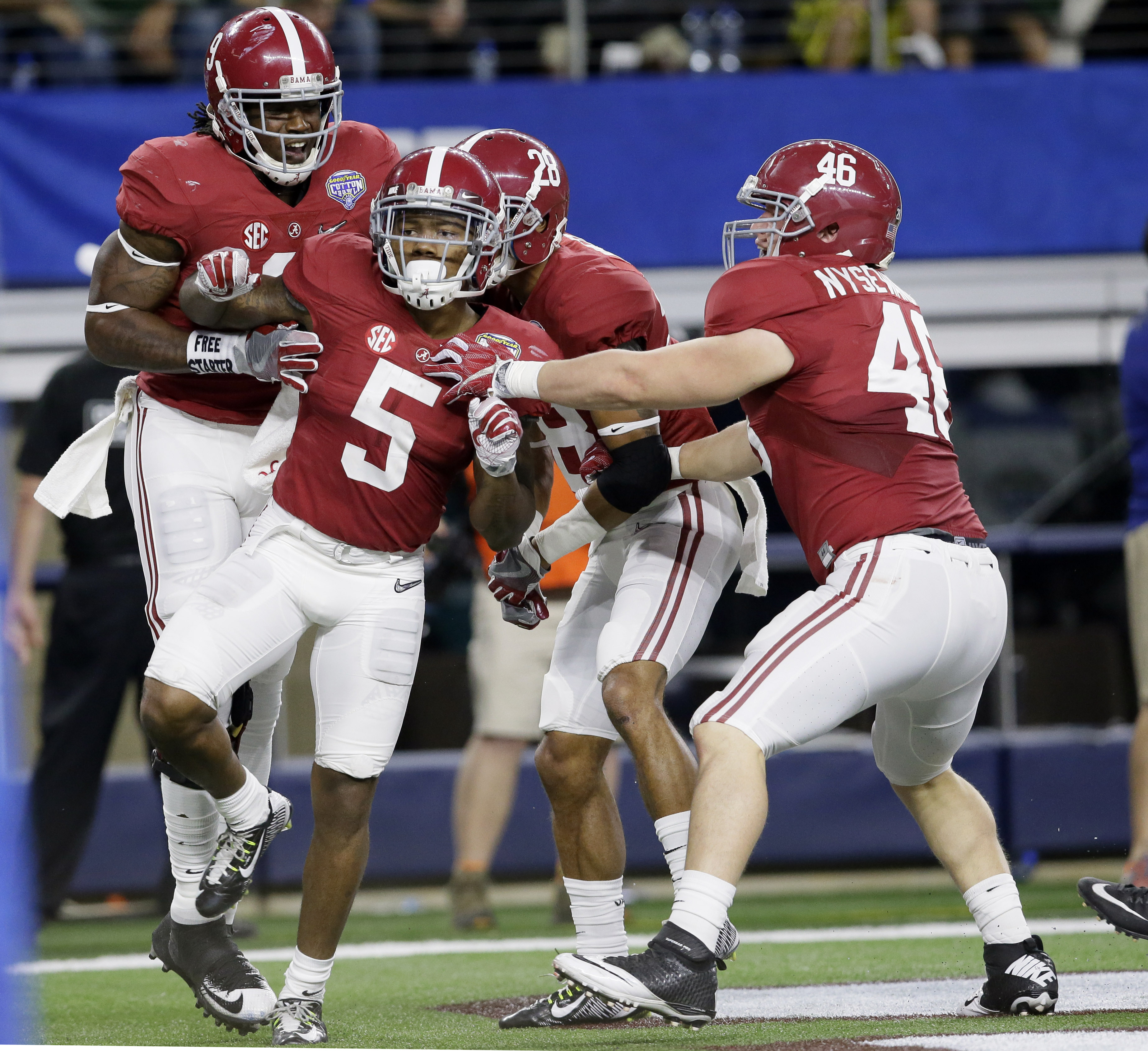 After scoring a touchdown against Michigan State, Alabama defensive back Cyrus Jones (5) celebrates with teammates during the second half of the Cotton Bowl NCAA college football semifinal playoff game, Thursday, Dec. 31, 2015, in Arlington, Texas. (AP Photo/LM Otero)