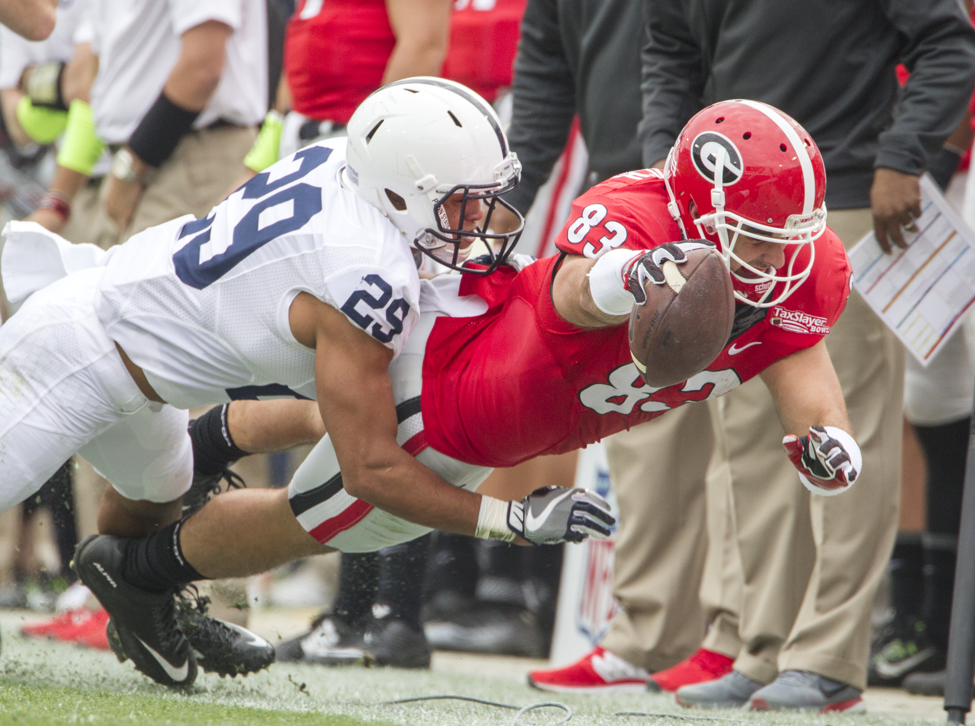 Georgia tight end Jeb Blazevich dives for extra yardage against Penn State cornerback John Reid during first half of the TaxSlayer Bowl NCAA college football game in Jacksonville, Fla., Saturday, Jan. 2, 2016. (AP Photo/Mark Wallheiser)