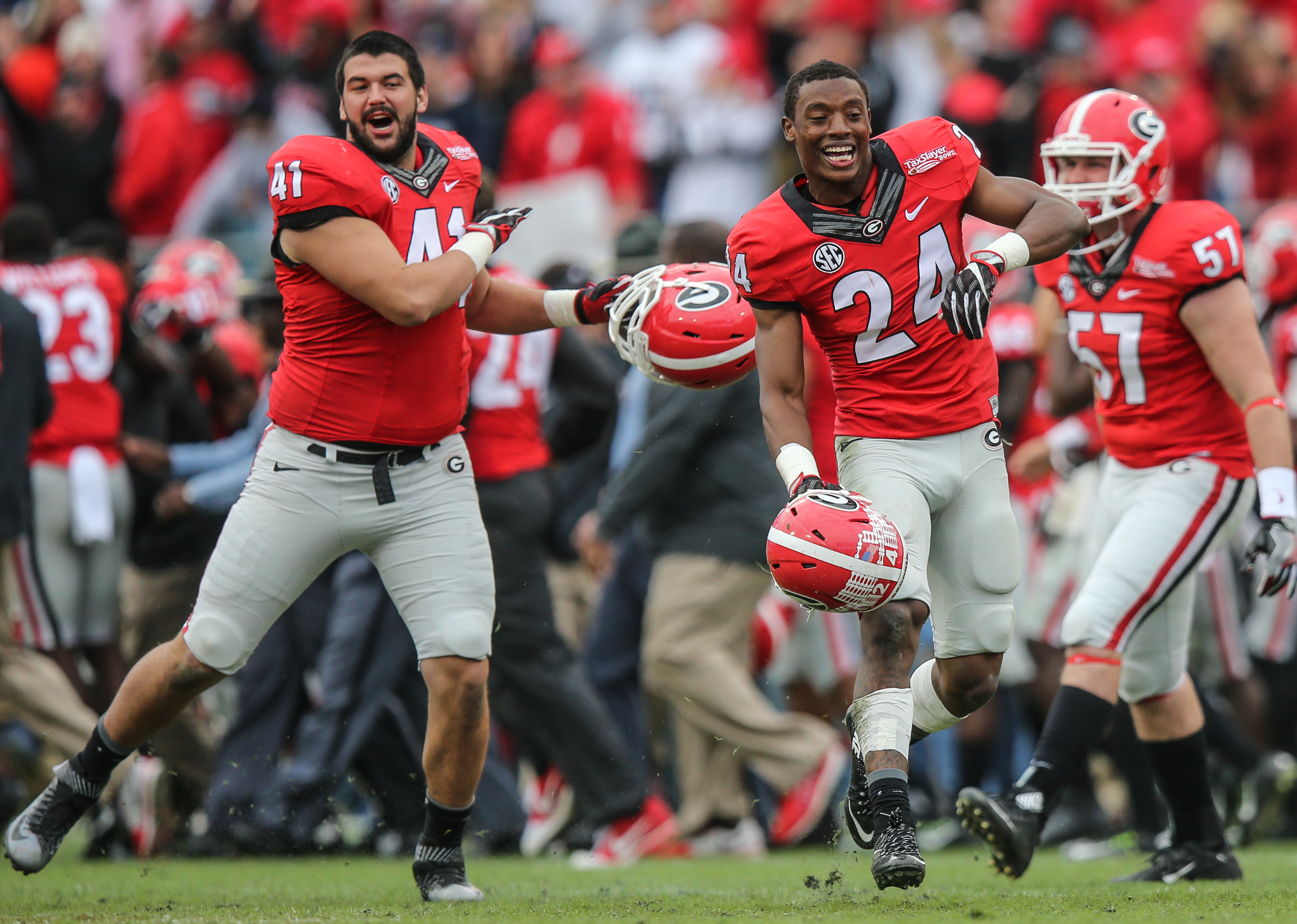 Georgia linebacker Chuks Amaechi (41) and safety Dominick Sanders (24) celebrate after defeating Penn State 24-17 in the TaxSlayer Bowl NCAA college football game, Saturday, Jan. 2, 2016, in Jacksonville, Florida. Georgia won 24-17. (Gary Lloyd McCullough/The Florida Times-Union via AP) MANDATORY CREDIT
