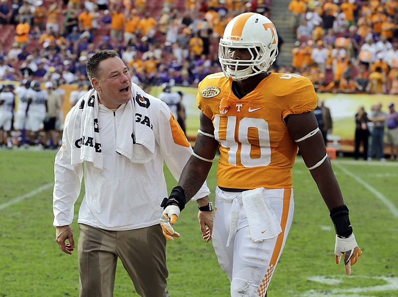 Tennessee coach Butch Jones talks to defensive lineman Dimarya Mixon during Friday's Outback Bowl victory over Northwestern in Tampa, Fla.