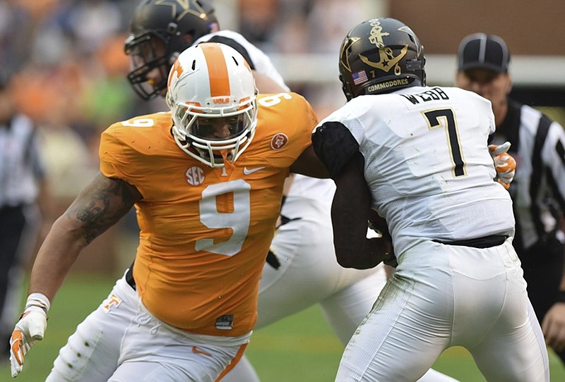 Tennessee's Derek Barnett (9) wraps up Vanderbilt's Ralph Webb (7).  The Vanderbilt Commodores visited the Tennessee Volunteers in SEC football action November 28, 2015.