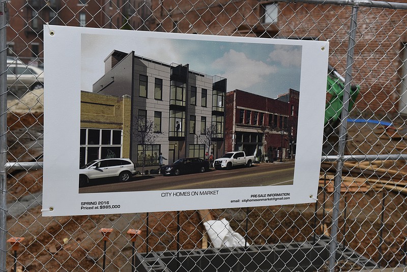 Photographed on Tuesday, Dec. 22, 2015, in Chattanooga, Tenn., a rendering of the City Homes on Market project is seen on a fence at the construction site directly across Market Street from the Chattanooga Choo Choo. 