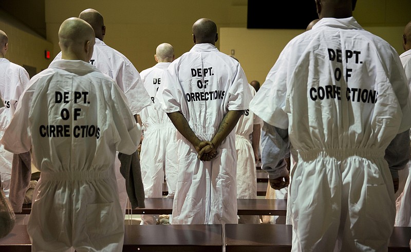 Prisoners stand while being processed for intake at the Georgia Diagnostic and Classification Prison, Tuesday, Dec. 1, 2015, in Jackson, Ga. They arrive by the busload each Tuesday and Thursday, dozens of new inmates entering Georgias prison system. Most stay only a week or two. But for those sentenced to die, this is their last stop. (AP Photo/David Goldman)