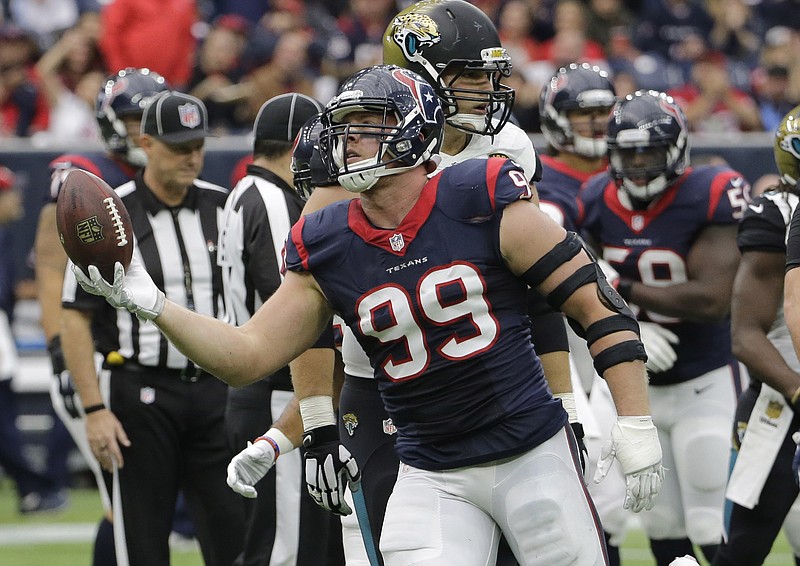 
              Houston Texans defensive end J.J. Watt (99) hold the football after recovering a Jacksonville Jaguars fumble during the first half an NFL football game Sunday, Jan. 3, 2016, in Houston. (AP Photo/David J. Phillip)
            