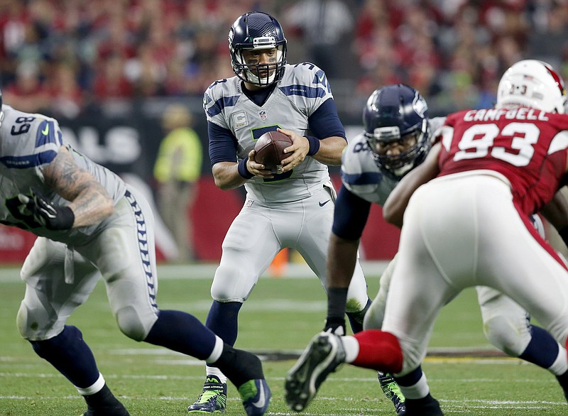 Seattle Seahawks quarterback Russell Wilson (3) takes the snap against the Arizona Cardinals during the first half of an NFL football game, Sunday, Jan. 3, 2016, in Glendale, Ariz.