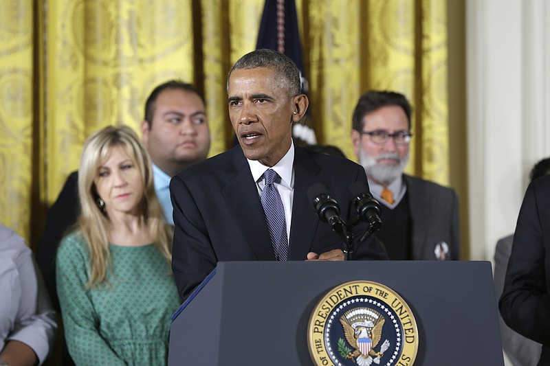President Barack Obama, joined by gun violence vuctims, speaks in the East Room of the White House in Washington, Tuesday, Jan. 5, 2016, about steps his administration is taking to reduce gun violence. Also on stage are stakeholders, and individuals whose lives have been impacted by the gun violence.