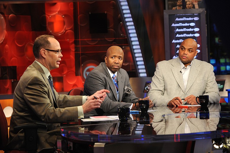 In this 2010 file photo, Inside the NBA host Ernie Johnson Jr., left, talks while analysts Kenny Smith, center, and Charles Barkley listen on the set at the TNT studios in Atlanta.