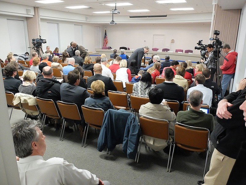 A large crowd waits for answers at the school board meeting room Wednesday.