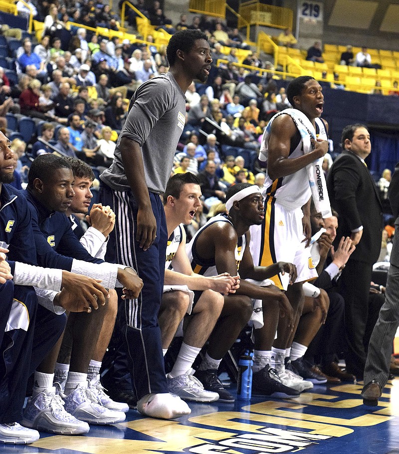 Staff Photo by Robin Rudd Injured UTC starter Casey Jones (standing center) looks on as the Mocs take a first half lead over Tennessee Tech. The Tennessee Tech Golden Eagles visited the Chattanooga Mocs in college basketball action at McKenzie Arena Tuesday December 15, 2015.