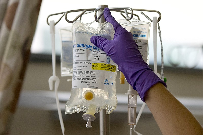 FILE - In this Tuesday, Aug. 4, 2015 file photo, a nurse places a patient's chemotherapy medication on an intravenous stand at a hospital in Philadelphia. (AP Photo/Matt Rourke, File)
            