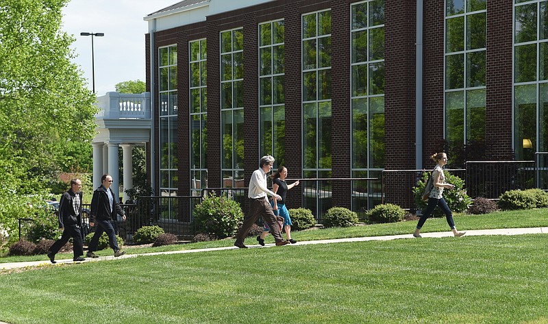 Southern Adventist University employees walk to a town meeting in the Iles Physical Education Center on Wednesday, Apr. 22, 2015, in Collegedale, Tenn. University President Gordon Bietz announced at the meeting that he will be stepping down in a year.