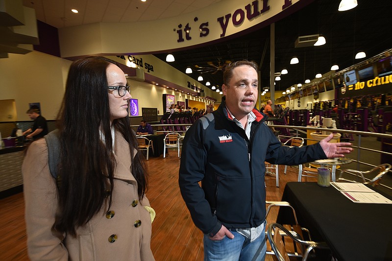 Planet Fitness franchisee Kira Ehly, right, and his marketing director, Cambrie Gustafson, talk about the newest location in Fort Oglethorpe Friday as business booms with early January exercise patrons.