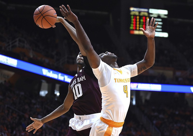 Texas A&M center Tonny Trocha-Morelos (10) blocks a shot by Tennessee forward Armani Moore (4) during the first half of an NCAA college basketball game in Knoxville, Tenn., Saturday, Jan. 9, 2016. (Adam Lau /Knoxville News Sentinel via AP) MANDATORY CREDIT