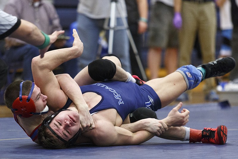 Cleveland's Colton Landers, left, tries to pin McCallie's Trent Walliser during their 132 lb championship bout in the Soddy-Daisy invitational wrestling tournament at Soddy-Daisy High School on Saturday, Jan. 9, 2016, in Soddy-Daisy, Tenn.
