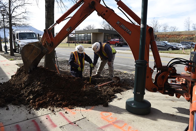 On Tuesday, Jan. 6, 2016, in Chattanooga, Tenn., Robert Conway, left, and Ray Hembree from the Chattanooga Gas Company work to disconnect a gas line from one of two buildings on Carter Street scheduled for demolition to make way for a new exit. Construction on Highway 27 will reshape the way the downtown area connects to the freeway. 