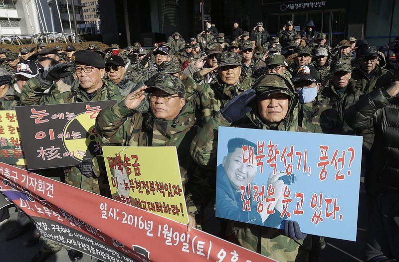 
              South Korean war veterans salute during a rally against North Korea in Seoul, South Korea, Saturday, Jan. 9, 2016. North Korea trumpets a hydrogen bomb test. South Korea responds by cranking up blasts of harsh propaganda from giant green speakers aimed across the world’s most dangerous border. The placards read "Anti-North Korea loudspeaker ? Leaflets? Kim Jong Un is smiling! and An eye for an eye, tooth for tooth, Nuclear for nuclear".  (AP Photo/Ahn Young-joon)
            