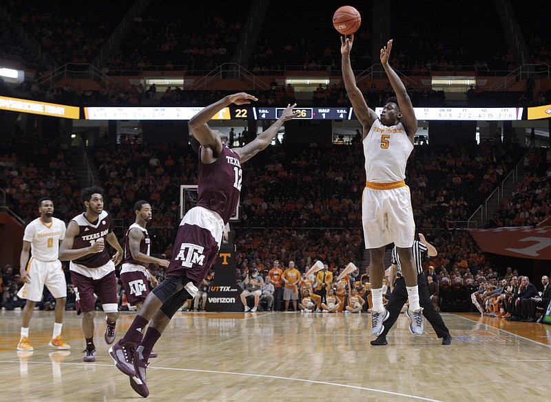 Tennessee's Admiral Schofield, right, shoots over Texas A&M guard Jalen Jones (12) during the first half of an NCAA college basketball game Saturday, Jan. 9, 2016, in Knoxville, Tenn. (AP Photo/Wade Payne)