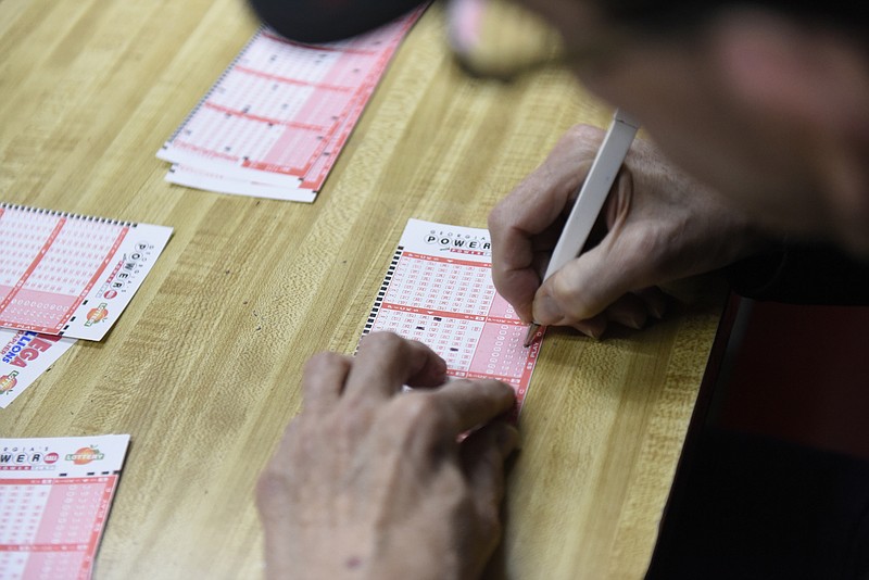 John Karr of Albertville, Ala., chooses his numbers on a Powerball entry form at the Smart Mart on Highway 301 in Dade County, Ga., just north of the state line on Sunday, Jan. 10, 2016, atop Sand Mountain near Trenton. A jackpot of over $1 billion is estimated if there is a single winner in Wednesday's drawing,. 