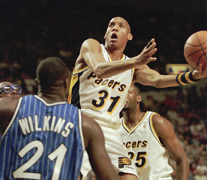 The Orlando Magic's Gerald Wilkins defends as the Indiana Pacers' Reggie Miller drives during a November 1996 game. Wilkins said he still keeps up with his alma mater, the UTC Mocs, and plans to visit Chattanooga later this season when his daughter's Furman Paladins play at McKenzie Arena.
